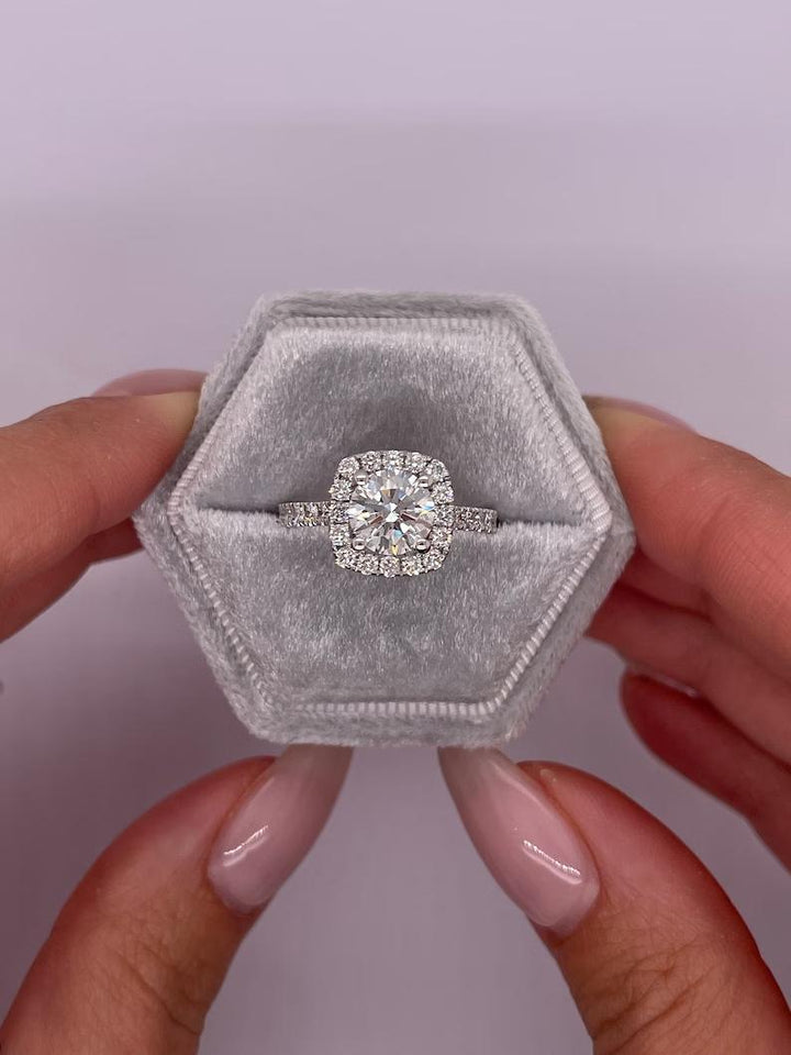 Round cut engagement ring shown with authenticity certificate