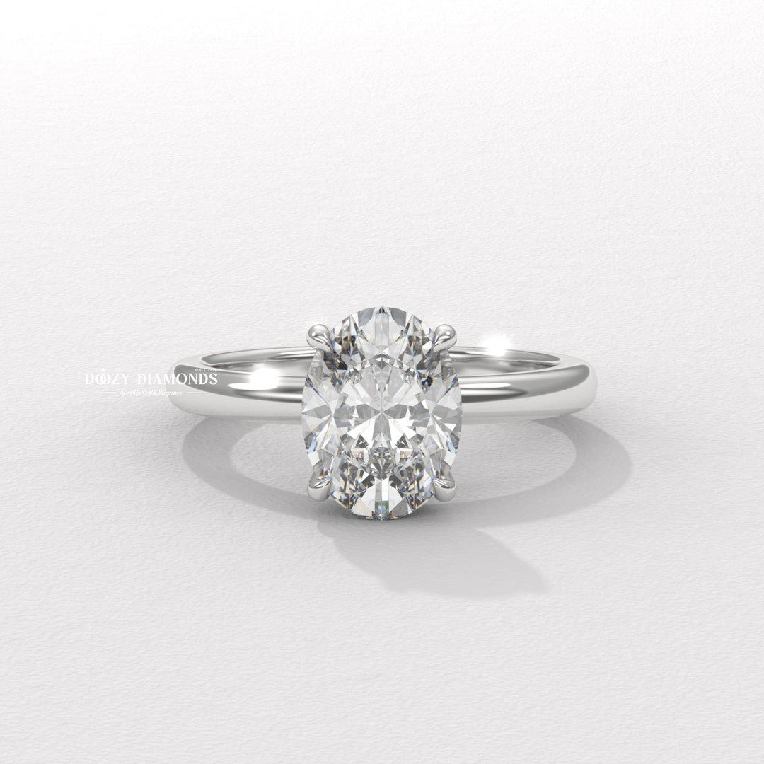 Oval hidden halo engagement ring viewed from the side