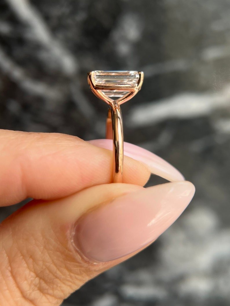 Angled view of emerald cut diamond in solitaire setting