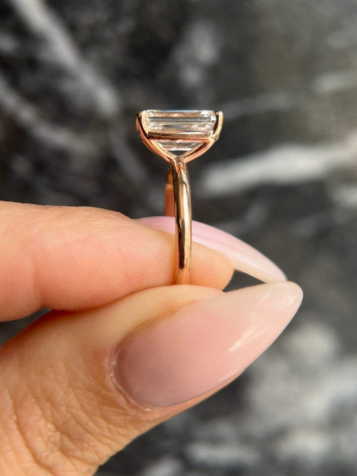 Angled view of emerald cut diamond in solitaire setting