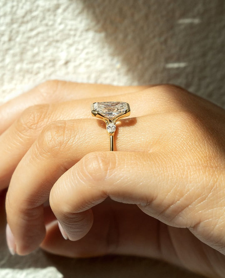 Profile view of radiant cut bezel engagement ring band