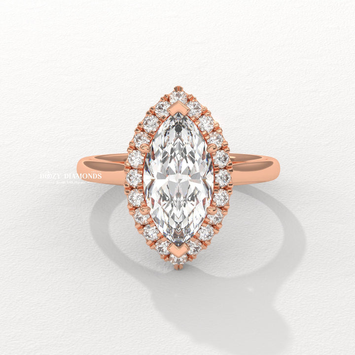 Macro shot of marquise cut diamond facets in halo ring setting