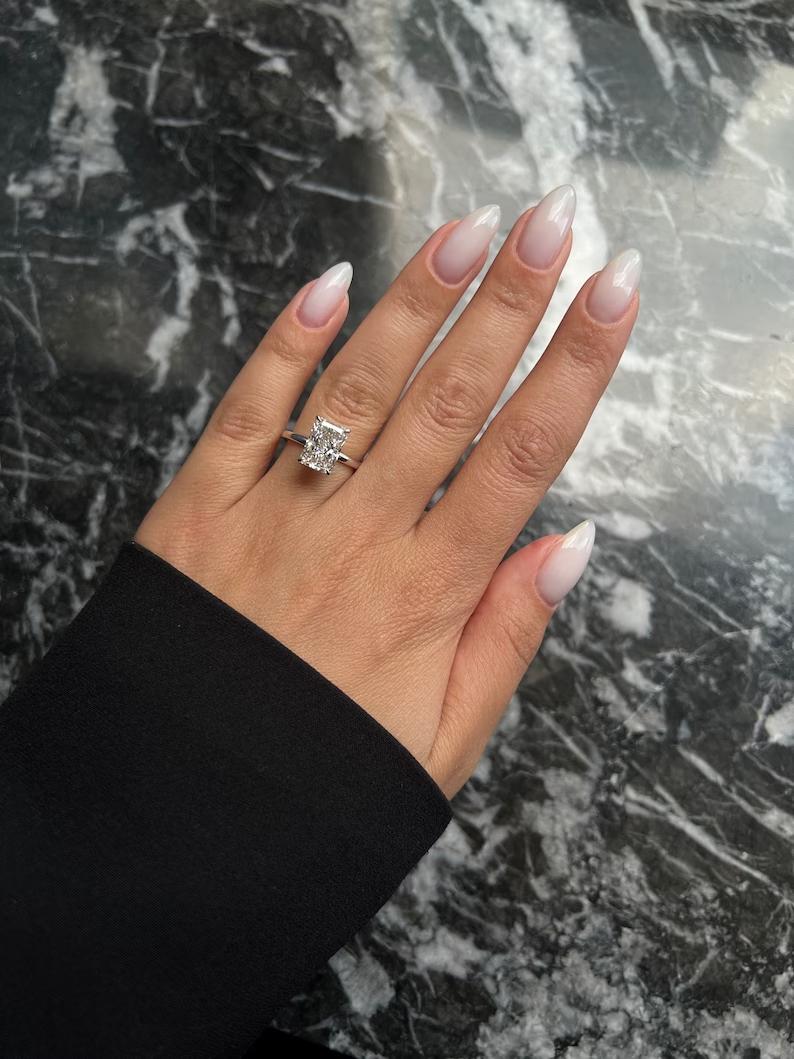 Lifestyle shot of radiant hidden halo diamond ring on hand