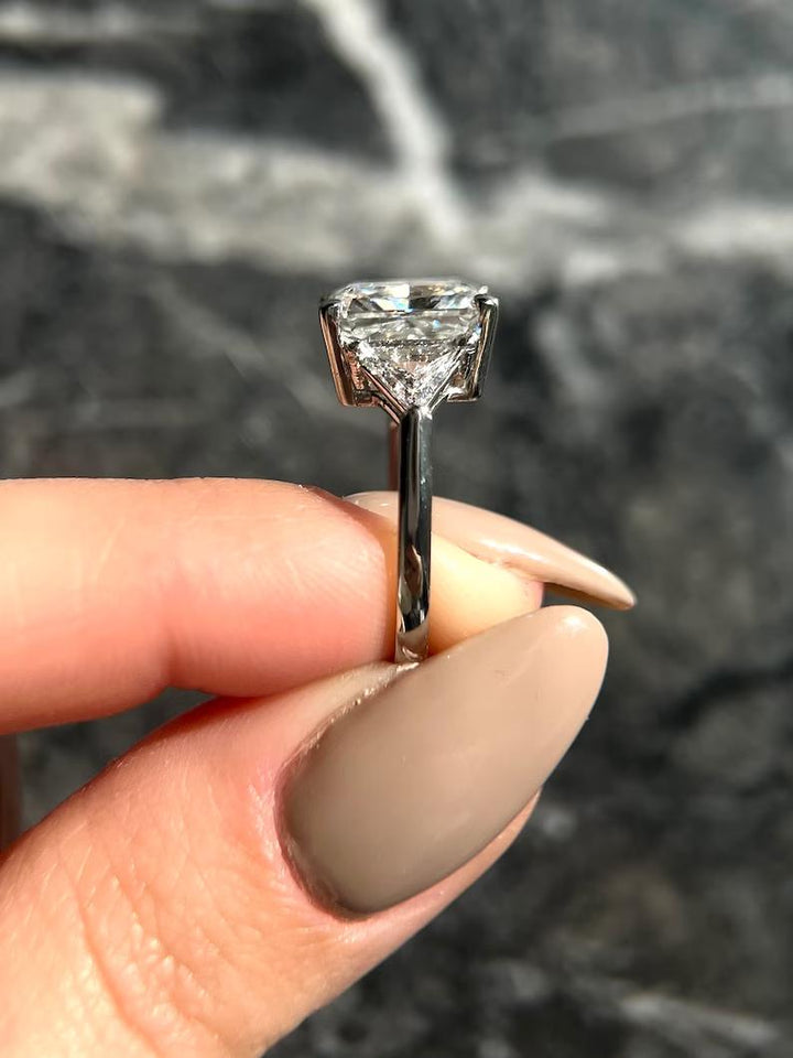 Radiant three stone ring set with an IGI graded diamond