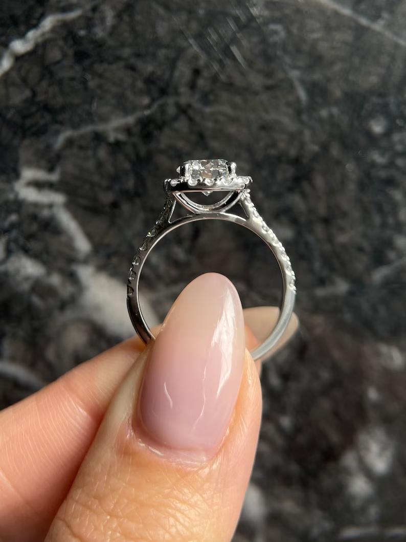 Unboxing view of round cut halo diamond engagement ring