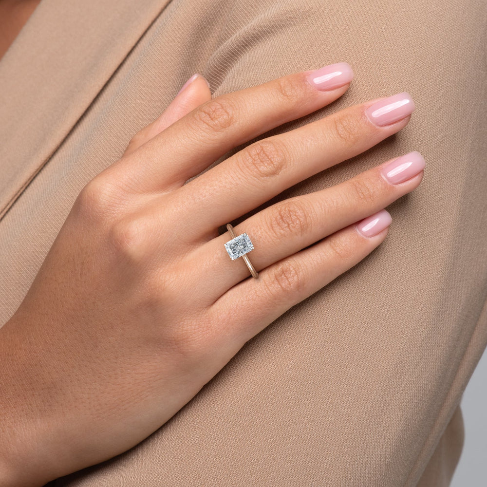Close-up of radiant cut center diamond in solitaire engagement ring