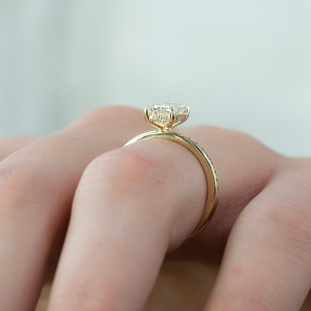 Certified emerald cut diamond featured in hidden halo engagement ring