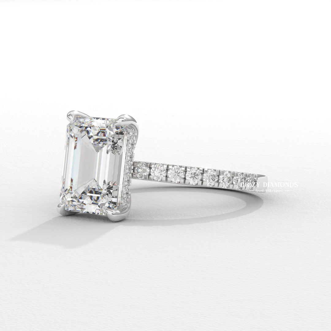 Profile view of emerald cut hidden halo engagement ring band