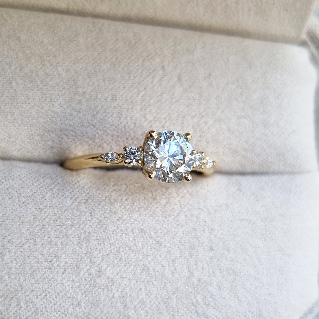Round cut engagement ring shown with authenticity certificate