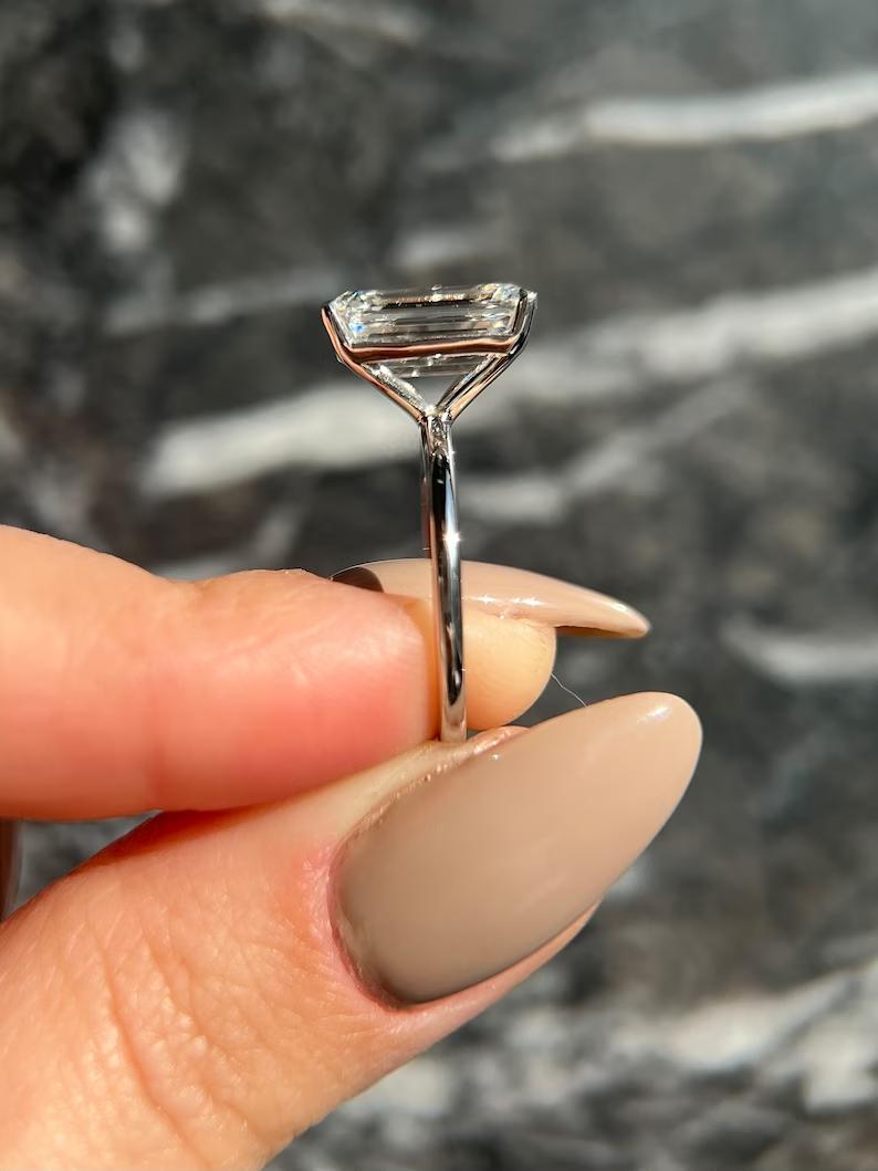 Fine craftsmanship detail on emerald solitaire engagement ring