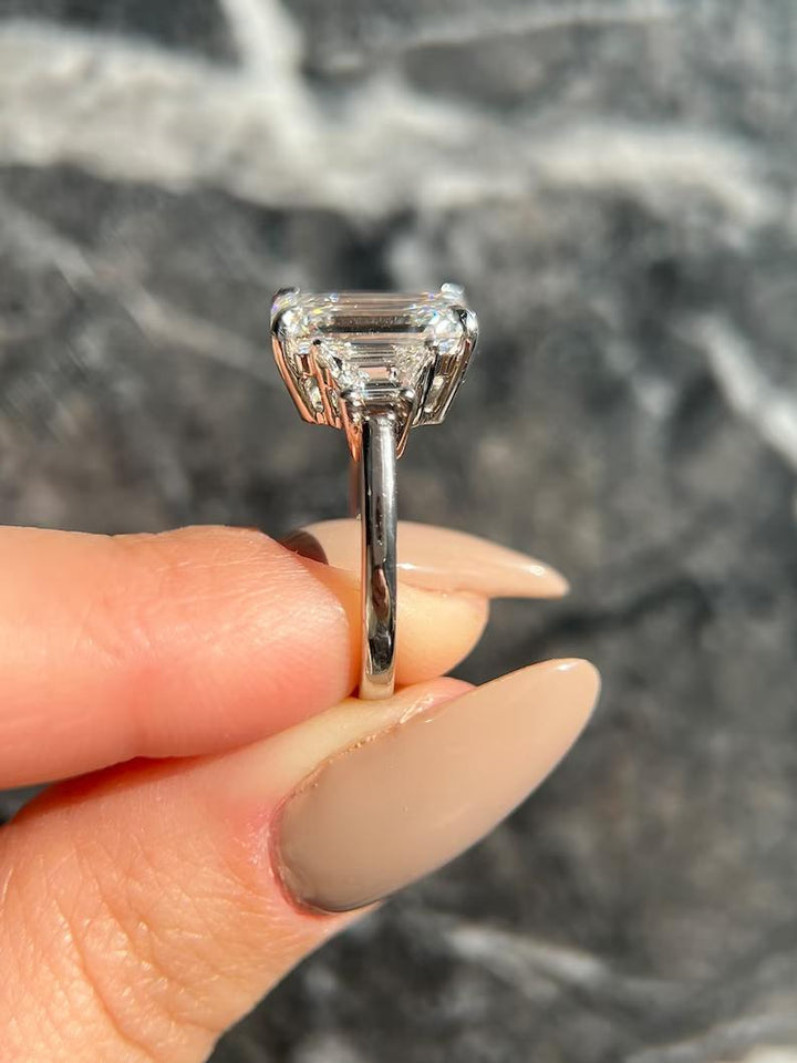 Emerald three stone lab grown diamond ring fitted on finger