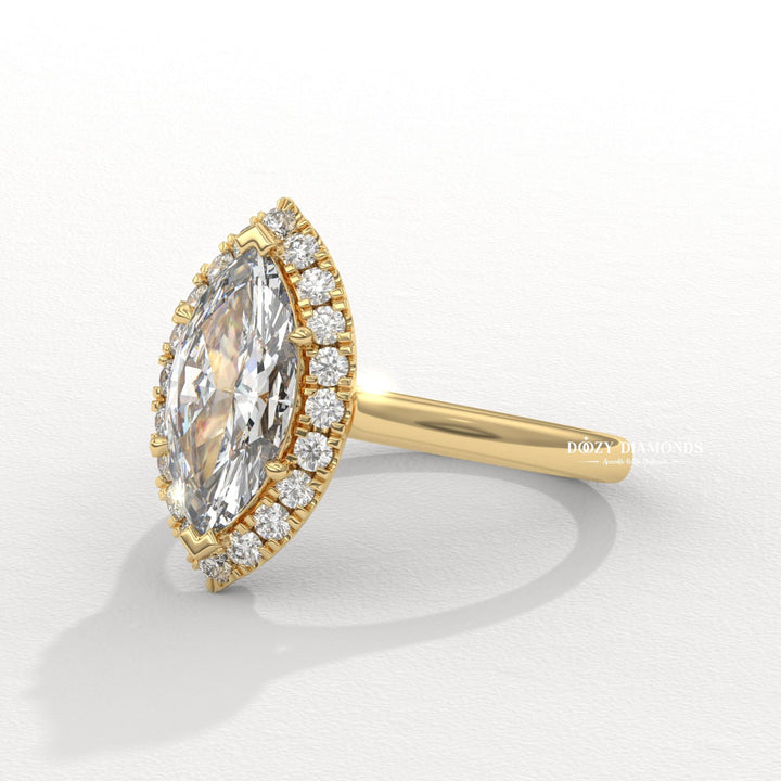 Close-up of marquise cut center diamond in halo engagement ring