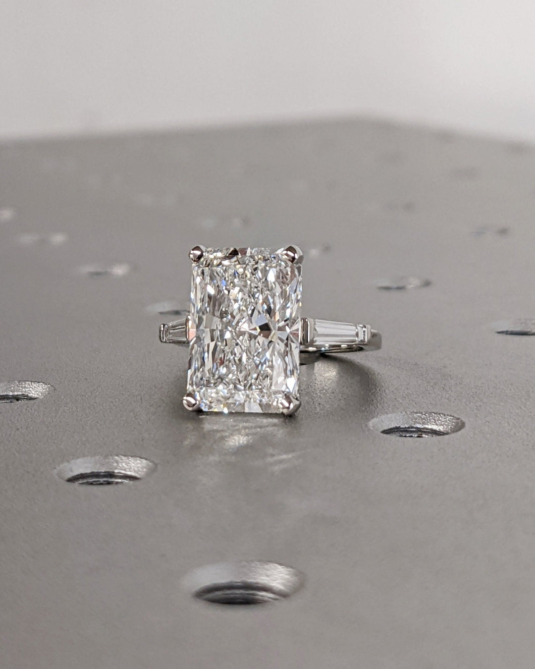 Detailed close-up of radiant three stone diamond engagement ring