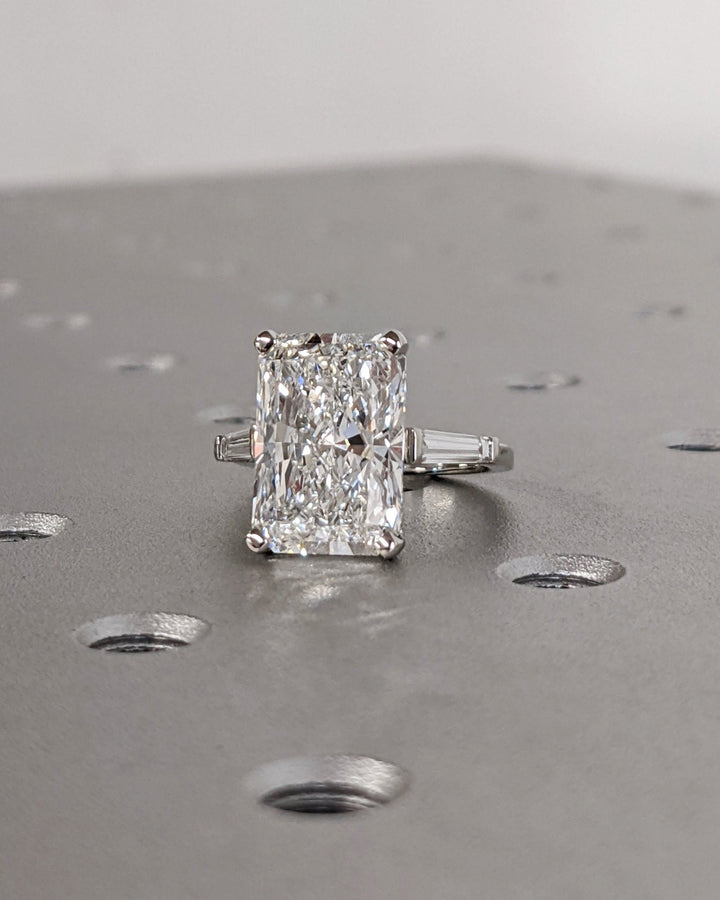 Detailed close-up of radiant three stone diamond engagement ring