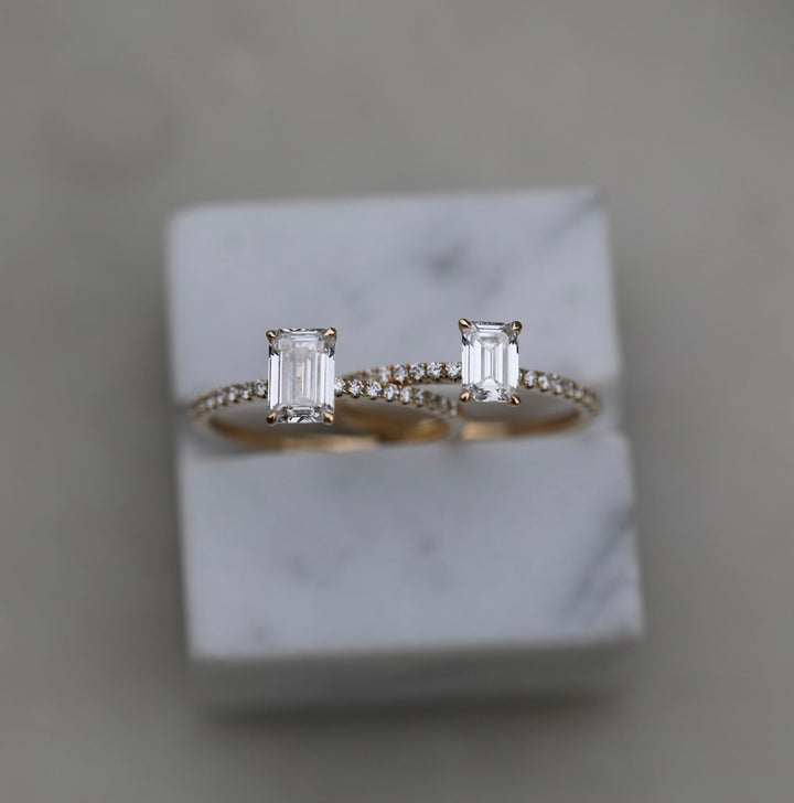 Emerald cut engagement ring shown with authenticity certificate