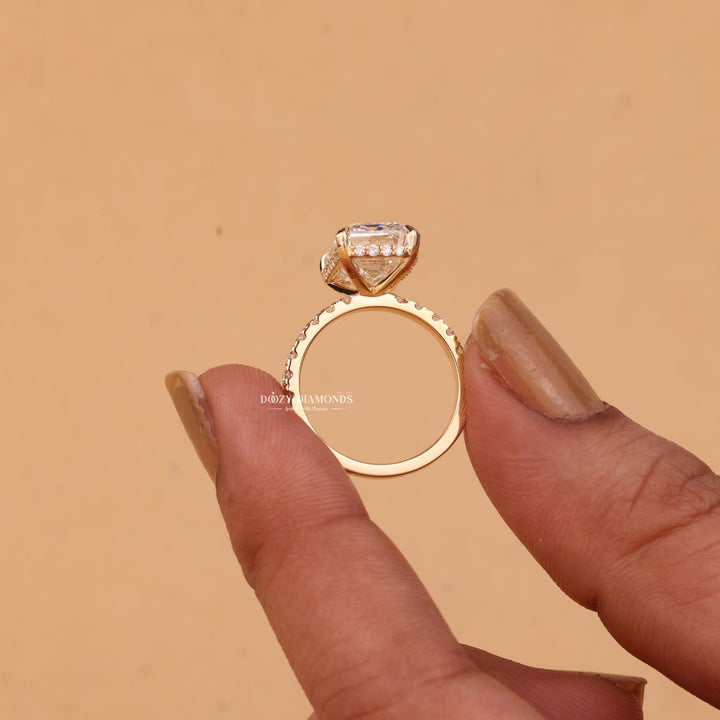 Fine craftsmanship detail on emerald hidden halo engagement ring