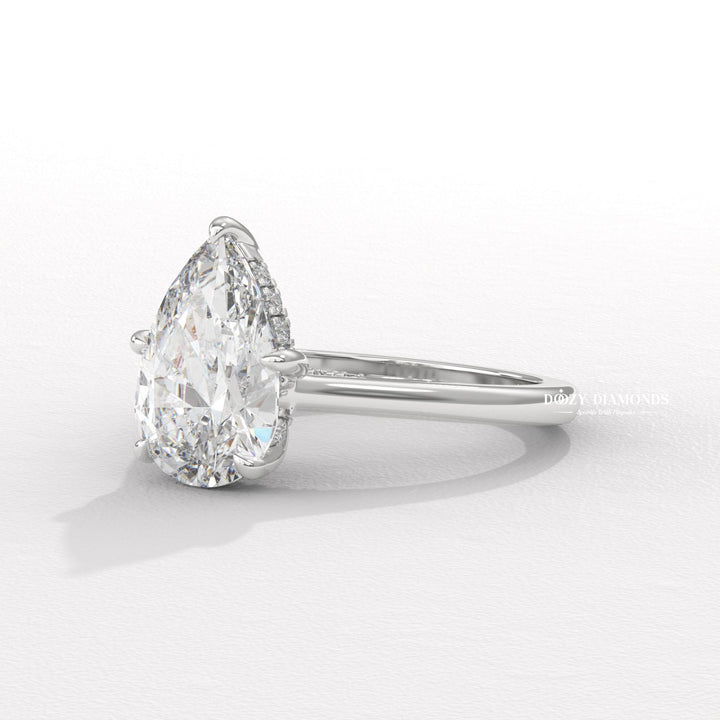 Pear solitaire engagement ring finished in polished solid gold