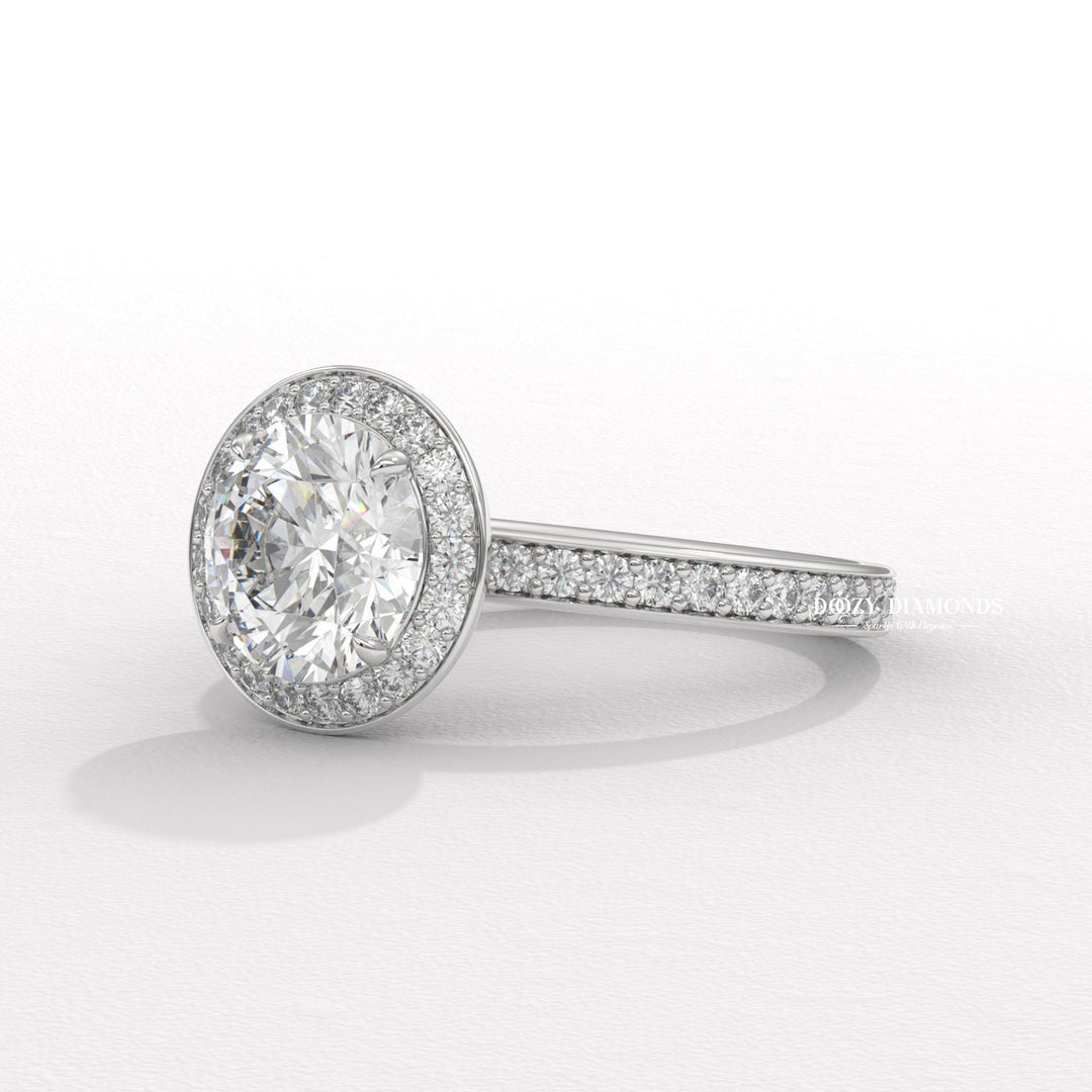 Close-up of round cut center diamond in halo engagement ring