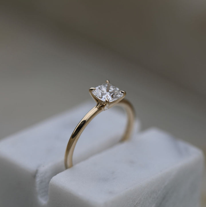 Cushion solitaire diamond engagement ring available in multiple metals