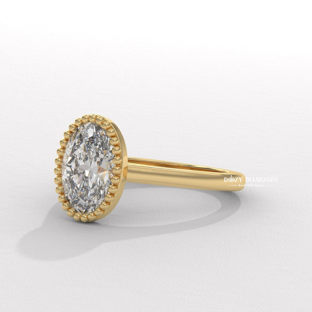 Oval bezel diamond ring displayed on jewelry stand
