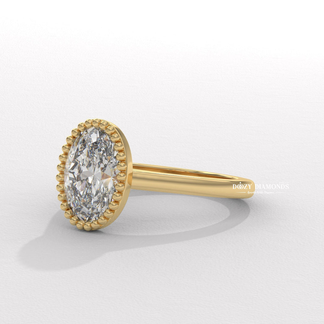 Oval bezel diamond ring displayed on jewelry stand