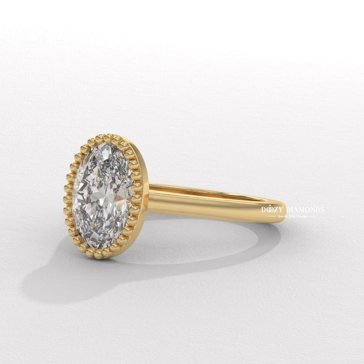 Oval bezel diamond ring displayed on jewelry stand