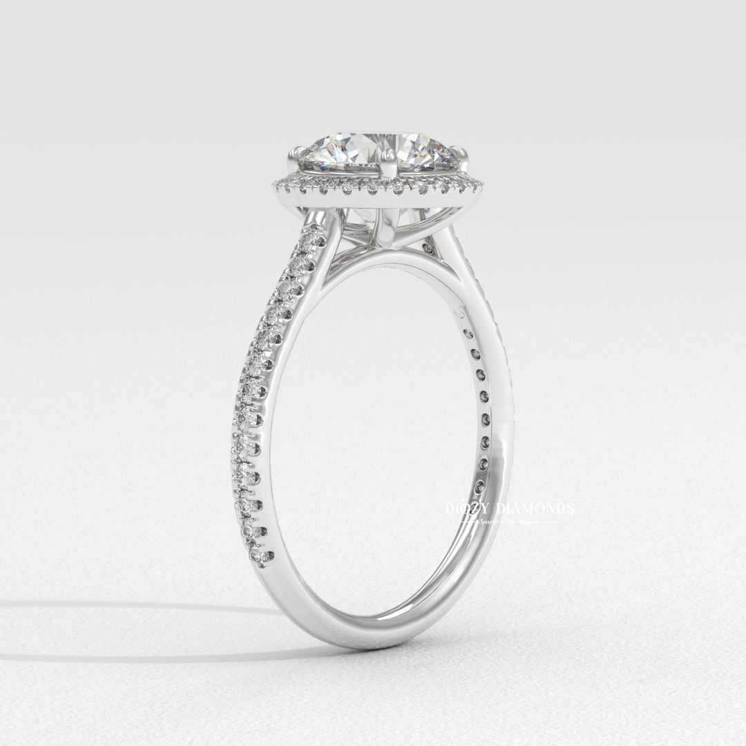 Close-up of round cut center diamond in halo engagement ring