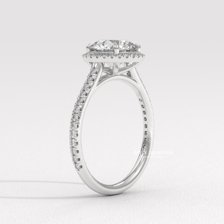 Close-up of round cut center diamond in halo engagement ring