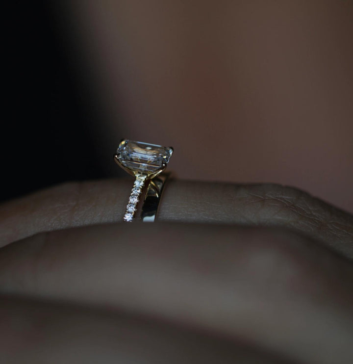 Emerald solitaire diamond engagement ring available in multiple metals