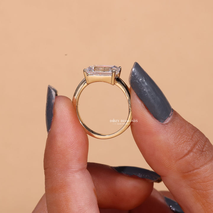 Macro shot of emerald cut diamond facets in east west ring setting