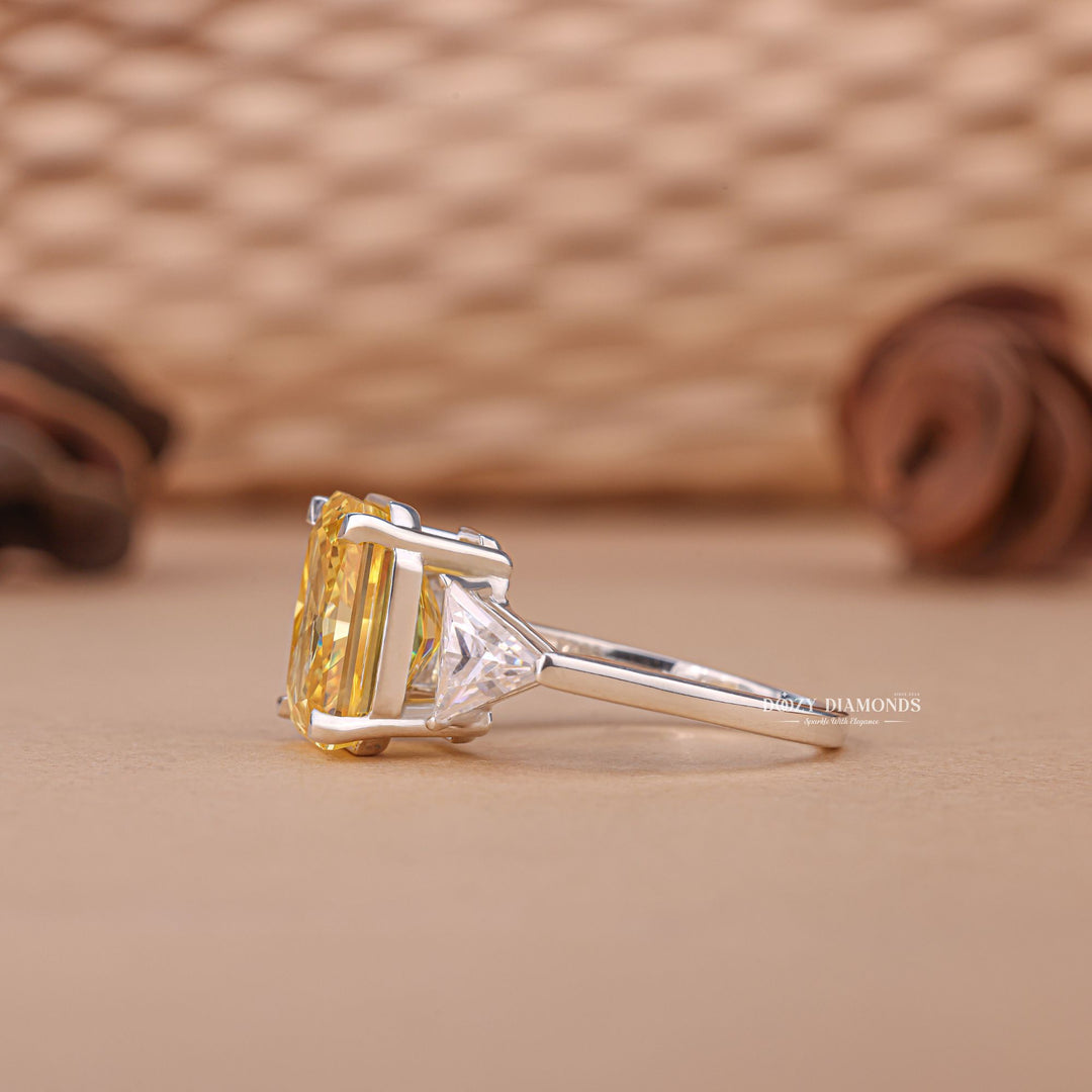 Close-up of radiant cut center diamond in three stone engagement ring