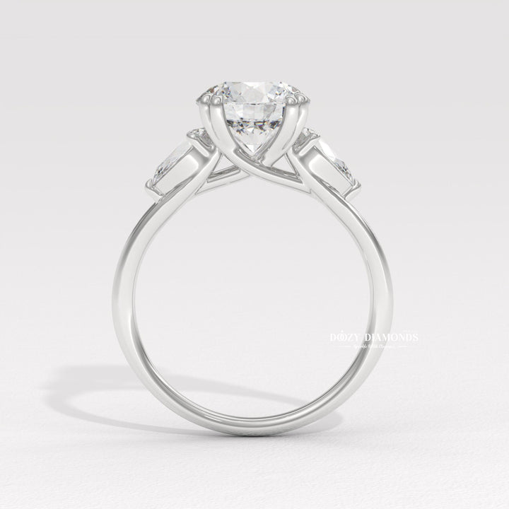 Round three stone engagement ring viewed from the side