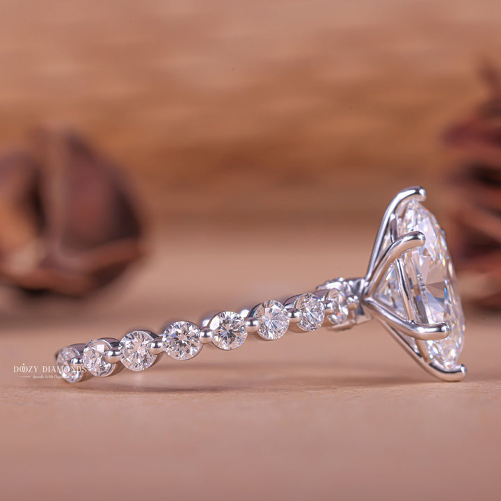 Macro shot of oval cut diamond facets in pave ring setting
