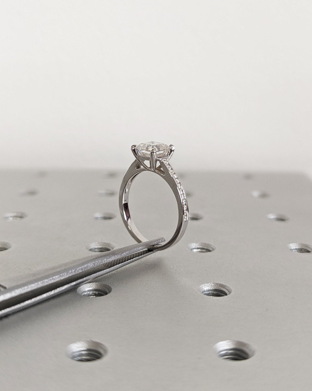 Macro shot of asscher cut diamond facets in solitaire ring setting