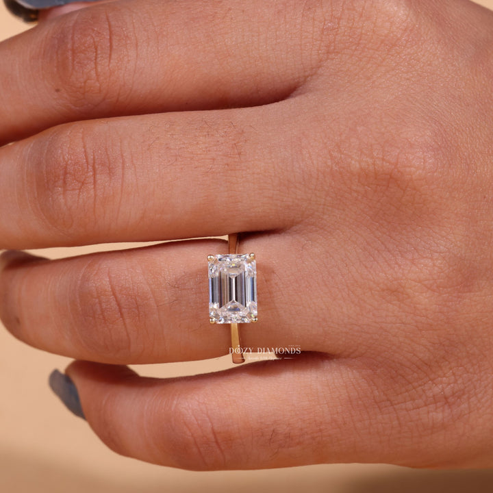 Emerald east west engagement ring close-up highlighting diamond sparkle
