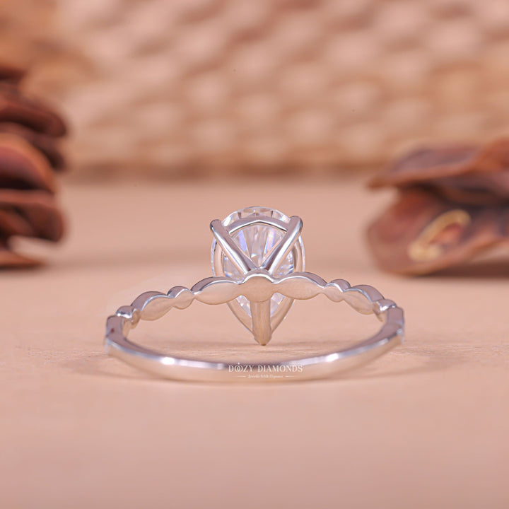 Pear cut engagement ring shown with authenticity certificate