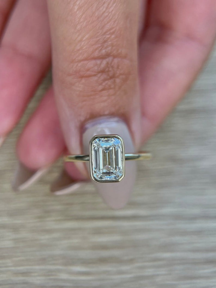 Top-down view of emerald cut bezel engagement ring