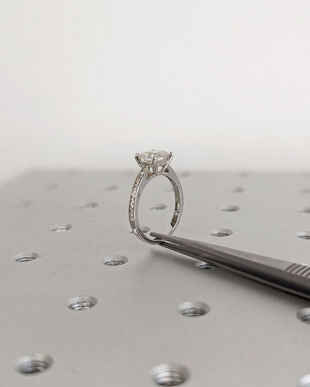 Detailed close-up of asscher solitaire diamond engagement ring