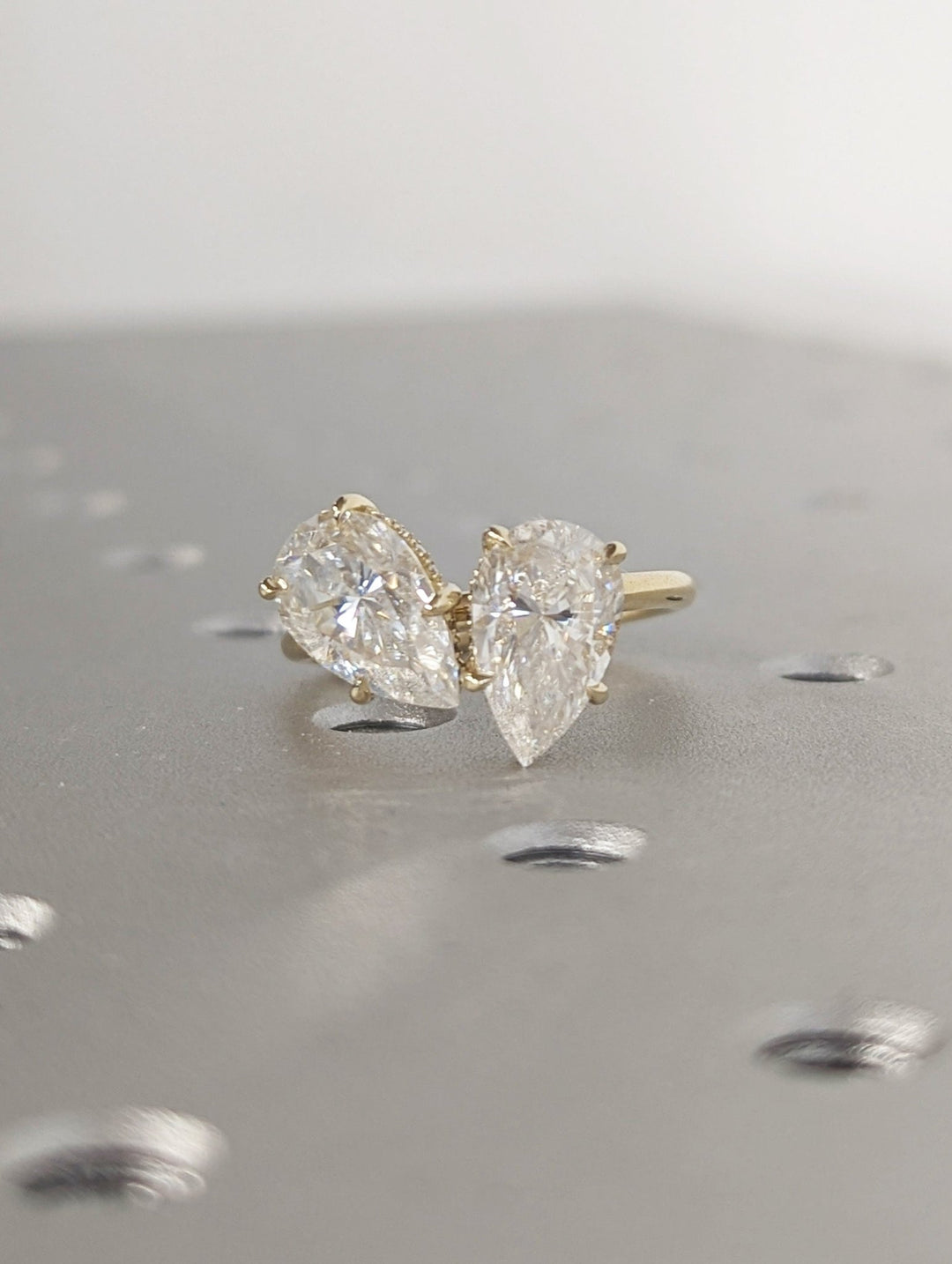 Profile view of pear cut hidden halo engagement ring band