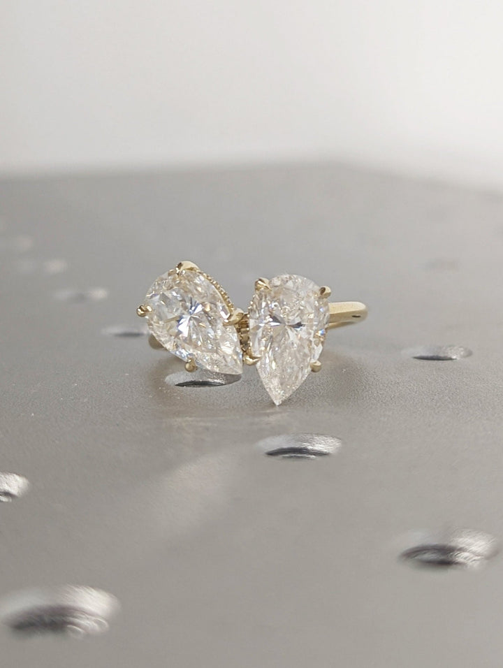 Profile view of pear cut hidden halo engagement ring band