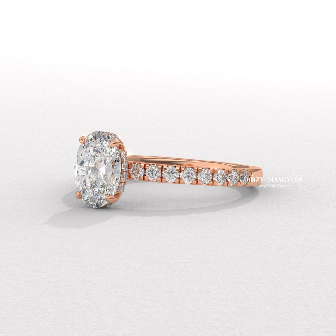 Oval hidden halo engagement ring close-up highlighting diamond sparkle