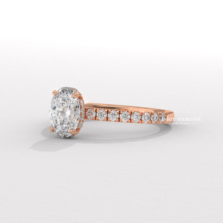 Oval hidden halo engagement ring close-up highlighting diamond sparkle