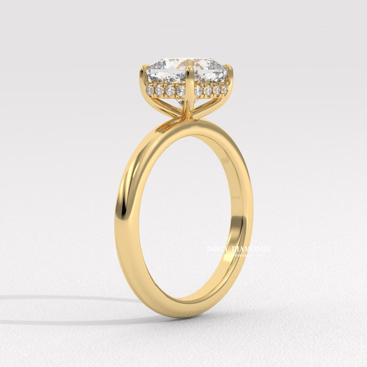Cushion hidden halo engagement ring shown on hand for true-to-life sizing