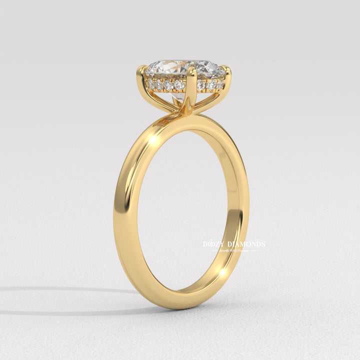 Close-up of oval cut center diamond in hidden halo engagement ring