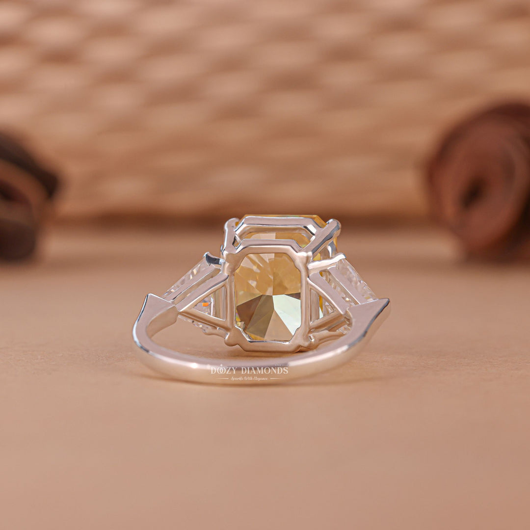 Macro shot of radiant cut diamond facets in three stone ring setting