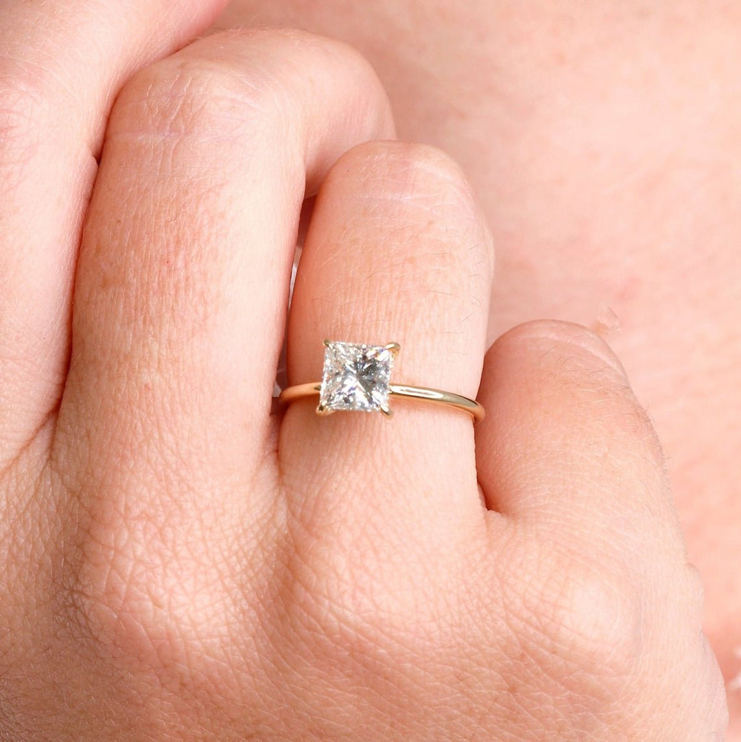 Princess hidden halo ring set with an IGI graded diamond