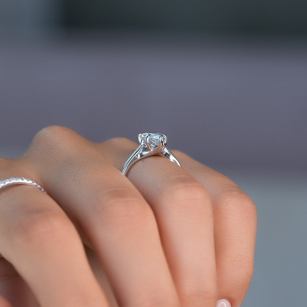 Pear solitaire engagement ring close-up highlighting diamond sparkle