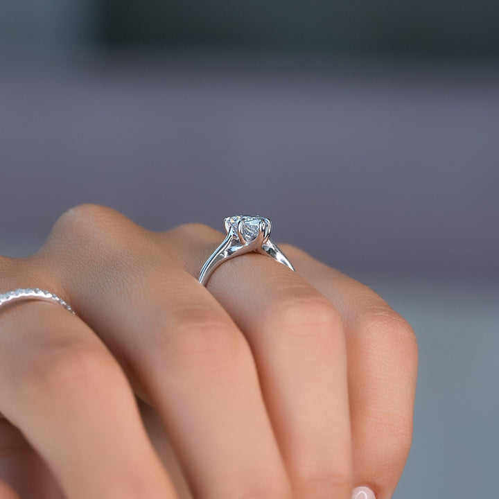 Pear solitaire engagement ring close-up highlighting diamond sparkle