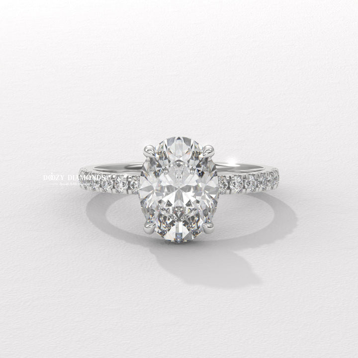 Close-up of oval cut center diamond in hidden halo engagement ring
