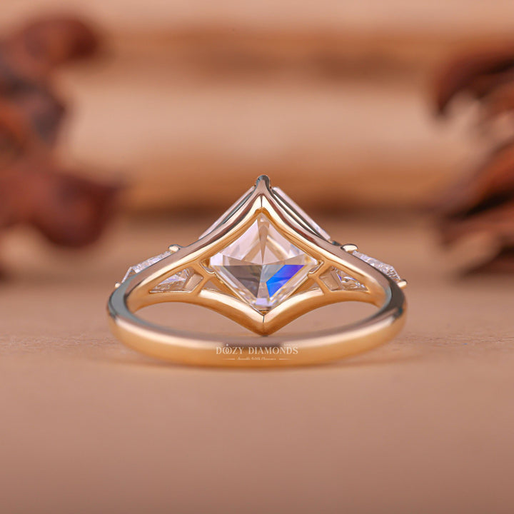 Asscher three stone engagement ring close-up showing E/VS1 diamond clarity